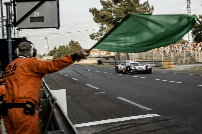 Marshal waving a green flag at a circuit
