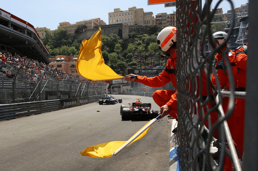 Marshal waving a yellow flag at the Monaco Grand Prix