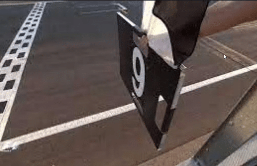 Black and white diagonal flag held with number 9 board