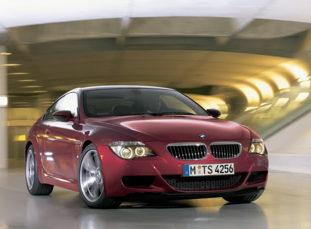 Red BMW M6 E63 coupe driving through a tunnel