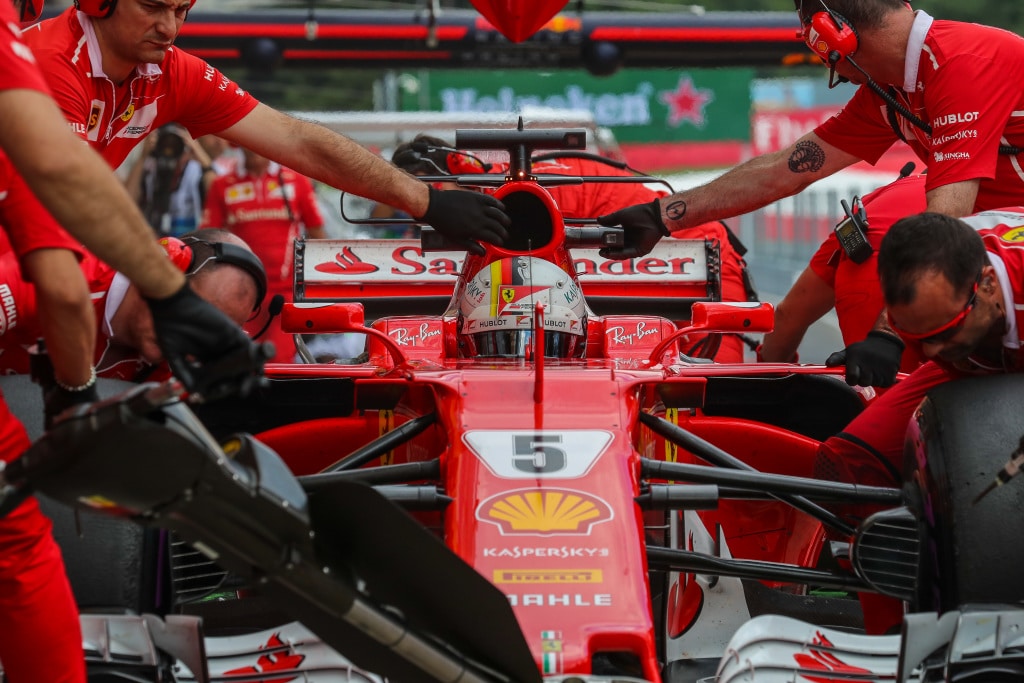 Ferrari pit crew stabilising car number 5 during a pit stop